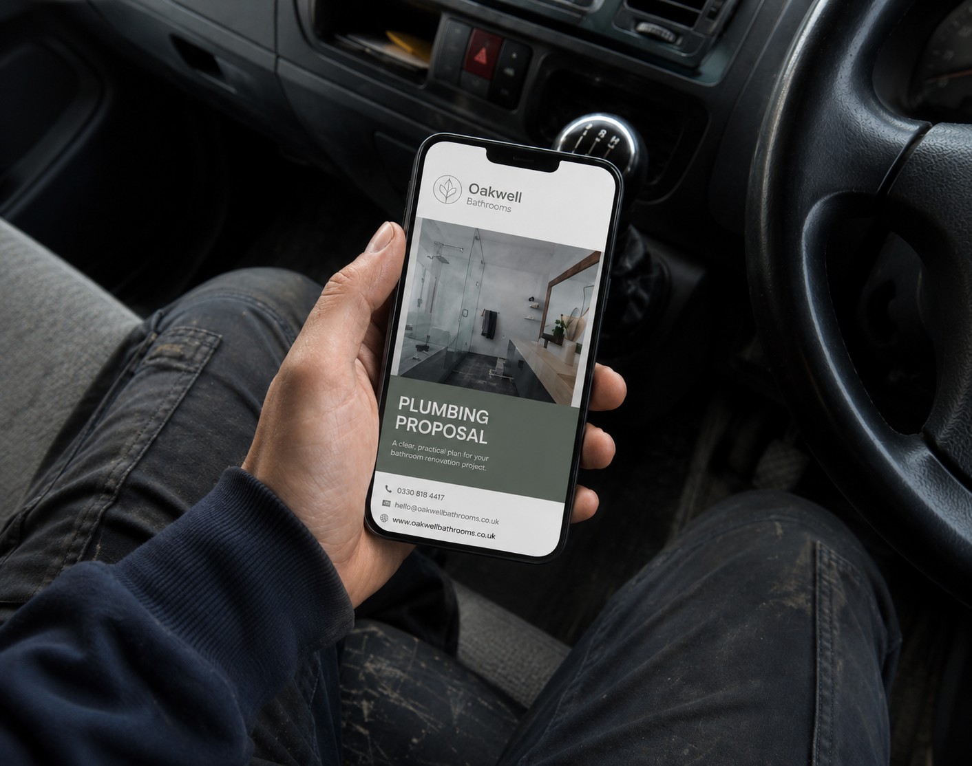 Plumber checking the proposal on a phone in the van